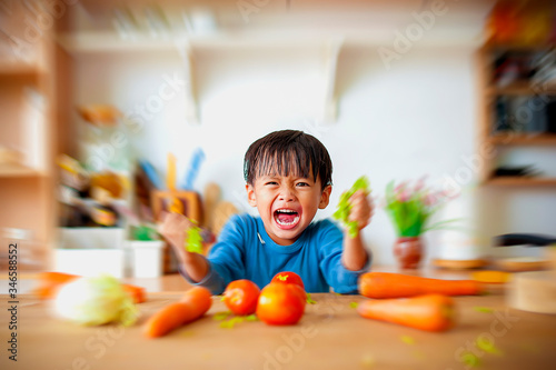 The boy who shows anger in the kitchen