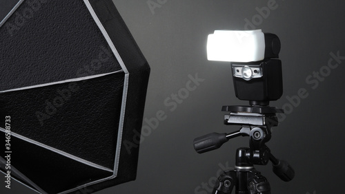 Studio light and back drop and soft box set up for shooting photo or video production which includes flashlight and continue lighting on tripod and paper background and used for photographer