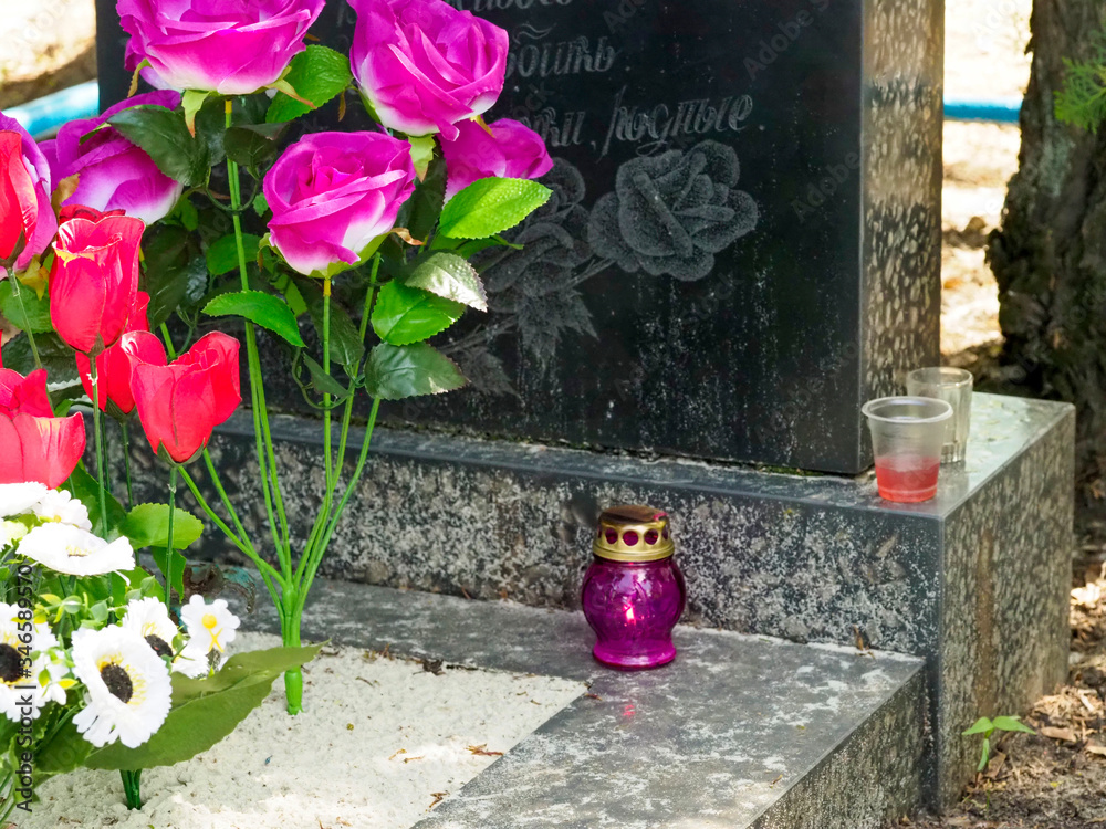 Marble tomb in the Orthodox cemetery. View of a granite grave in a cemetery Marble tomb in the Orthodox cemetery. View of a granite grave in a cemetery
