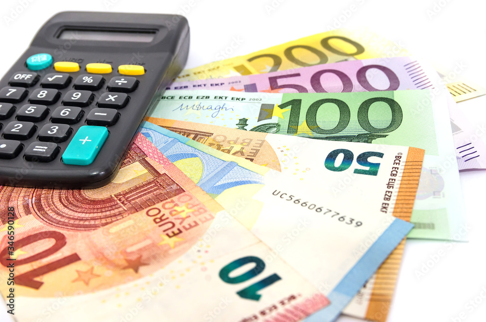 different euro banknotes and calculator on white different euro banknotes and calculator on white