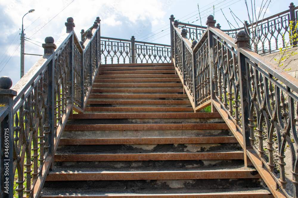 Old rusty iron staircase. the railings and steps were stained with rust. Old rusty iron staircase. the railings and steps were stained with rust.