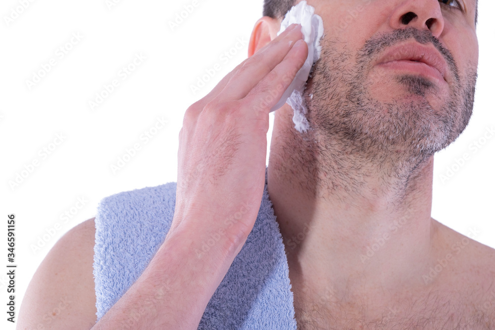 Obraz premium man puts shaving foam on his face