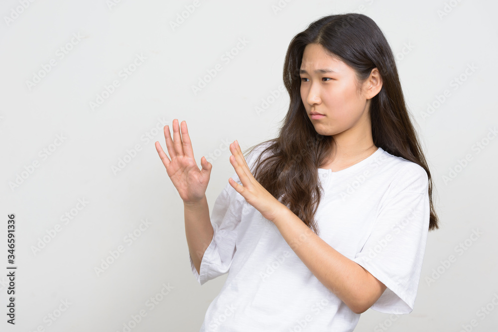 Portrait of stressed young Asian woman with stop gesture Portrait of stressed young Asian woman with stop gesture