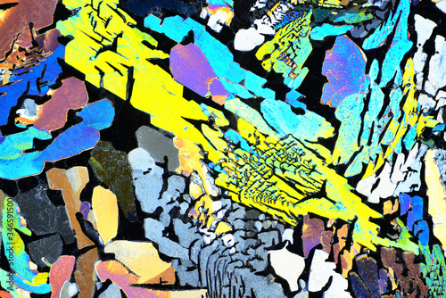 Colorful micro crystals in polarized light. Photo through a microscope.