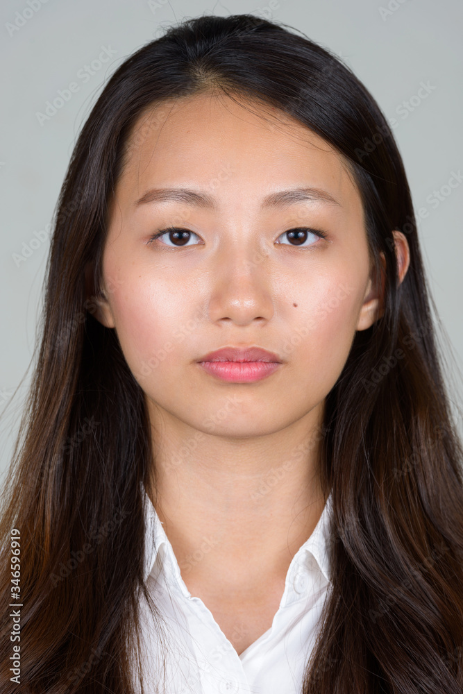 Face of young beautiful Asian businesswoman looking at camera Face of young beautiful Asian businesswoman looking at camera