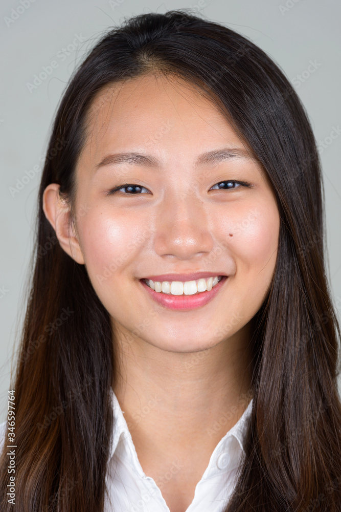 Face of happy young beautiful Asian businesswoman smiling Face of happy young beautiful Asian businesswoman smiling