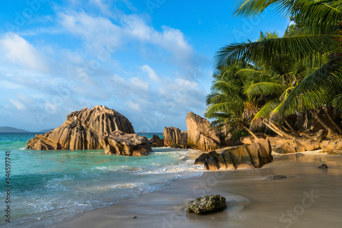 Anse Patates at La Digue, Seychelles. Small and beautiful beach, surrounded by granite boulders and coconut palms. Shot at sunset.