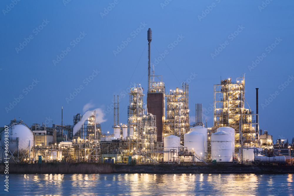 Chemical Plant or Factory Along a River with Lights On Chemical Plant or Factory Along a River with Lights On