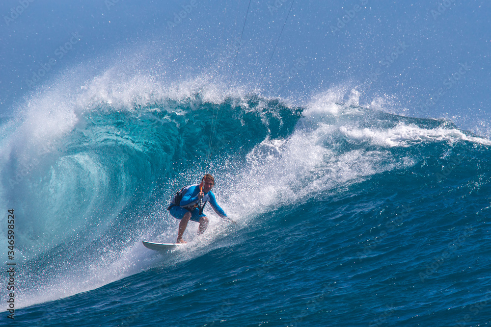 Kite surfer rides among the huge tubes and waves of the Indian Ocean on the island of Mauritius Kite surfer rides among the huge tubes and waves of the Indian Ocean on the island of Mauritius