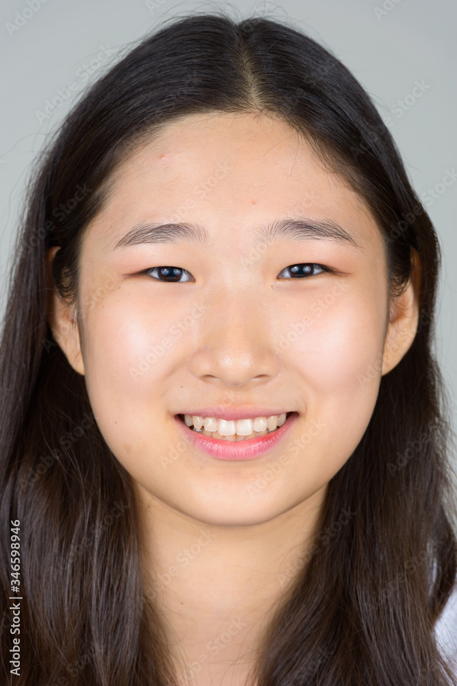 Face of happy young beautiful Asian woman smiling Face of happy young beautiful Asian woman smiling