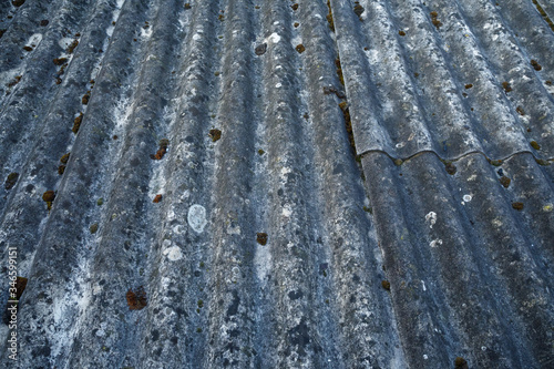 A heavily aged and weathered asbestos cement roof