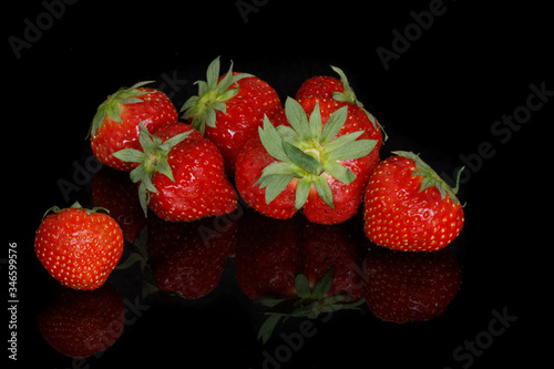 Fresh red ripe strawberries on a black background