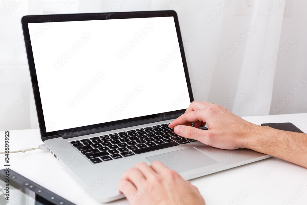 Back view of male person sitting front open laptop computer with blank empty screen for your information or content, modern businessman working in internet Back view of male person sitting front open laptop computer with blank empty screen for your information or content, modern businessman working in internet