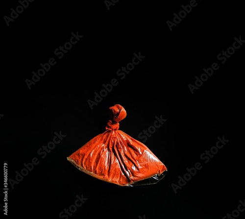 Bag with annatto on black background. Guatemala spices photo