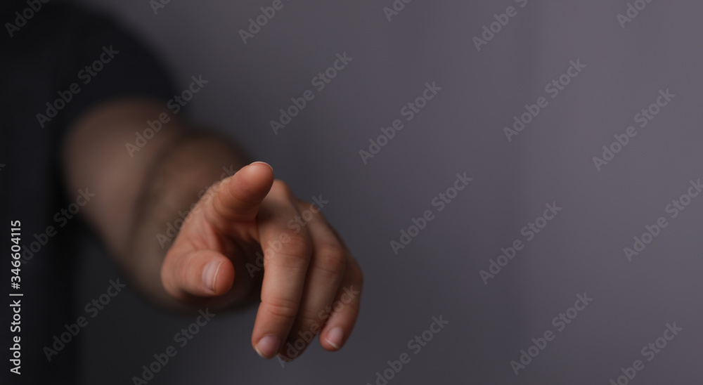 Obraz premium A man hand touching virtual screen, modern background concept , can put your text at the finger, copy space.