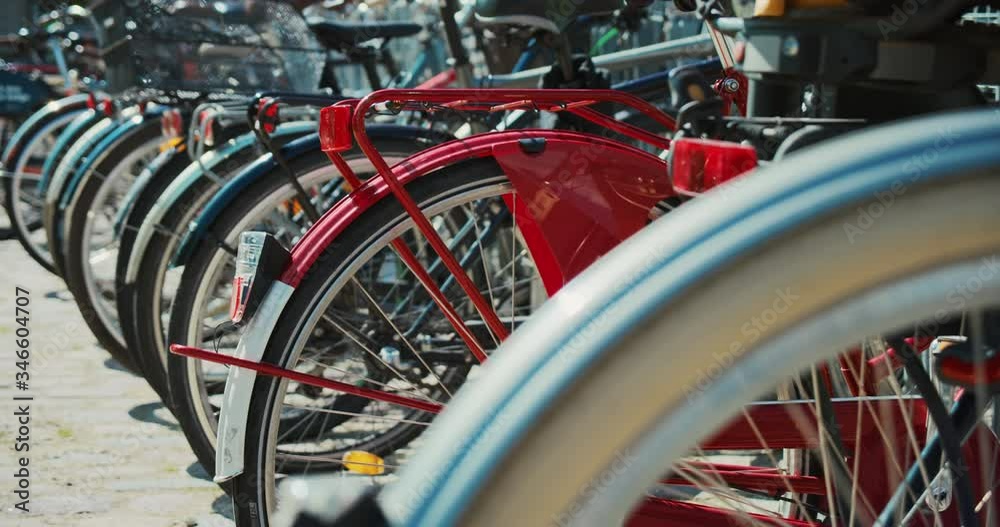 Bicycle parking of commuter city bikes in Copenhagen or Amsterdam. Cycling infrastructure optimised for comfort and usability of cyclists. Safe storage spot at train station or business hub