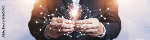 Banner, businessmen asia holding light bulbs, ideas of new ideas with innovative technology and creativity, On a white sky background. The conceptual imagination of ideas with bulbs that shine glitter