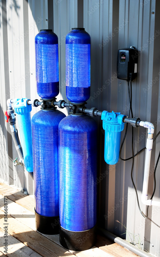 Whole house water filter - Modern reverse osmosis system outdoors on metal  wall background. Stock Photo | Adobe Stock