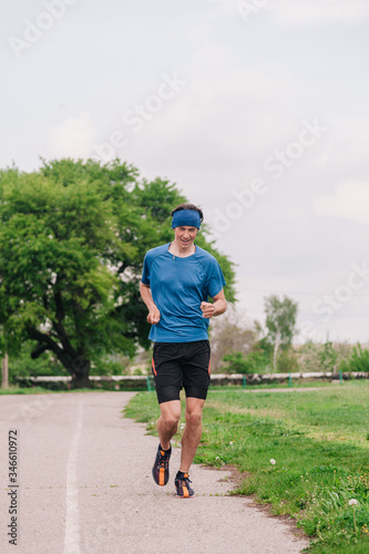 young guy runs morning stadium workout