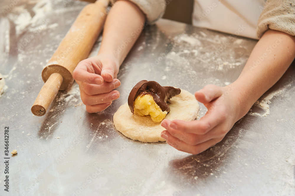 young children fill a flour product with a sweet filling. Master class baking young children fill a flour product with a sweet filling. Master class baking