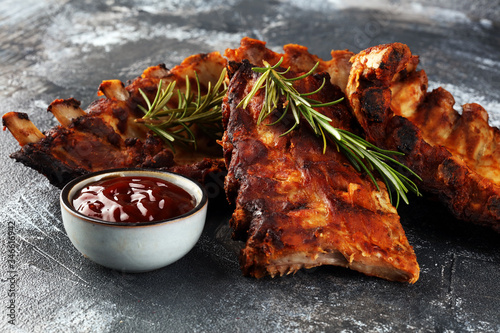 Grilled spare ribs for a tasty bbq meat with hot spicy barbecue sauce photo