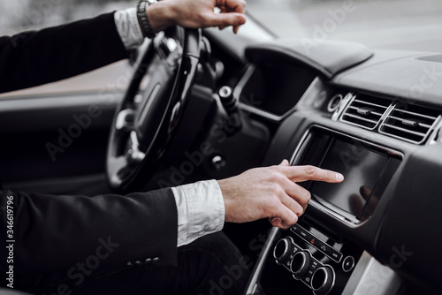Businessman touching screen in modern car dashboard © Monako Art Studio