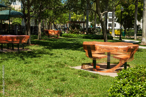 Empty playground with tables covered with orange polyethylene film and other equipment in the city park. Space for Copy. Outbreak of Covid-19. Stay at home