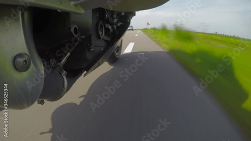 Video onboard on a motorcycle at the footpeg foot support low to the ground pov photo
