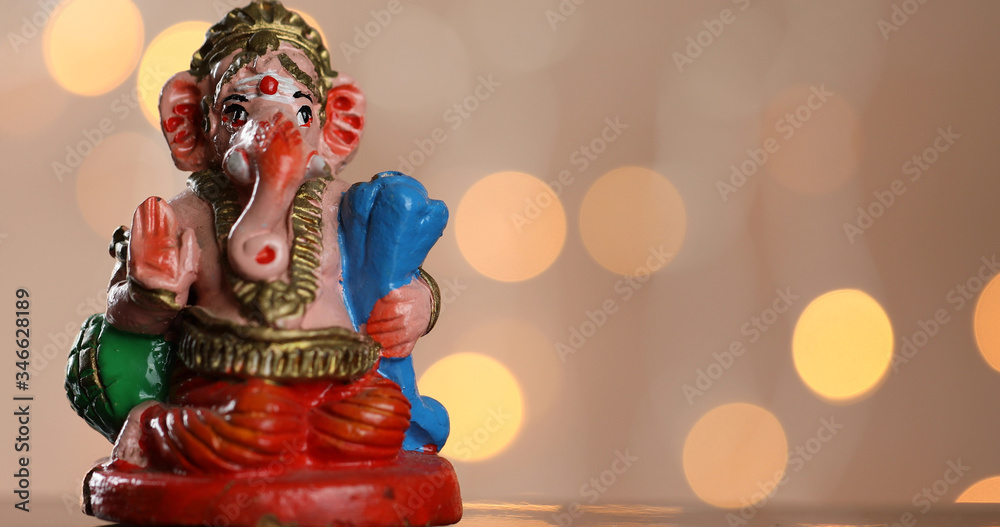 Symbolic and colourful Lord Ganesha on a bokeh lights background