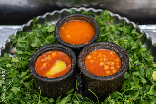 Abgoosht, also called Dizi, is an Iranian stew. Hearty mutton Persian soup thickened with chickpeas in metal pots. photo