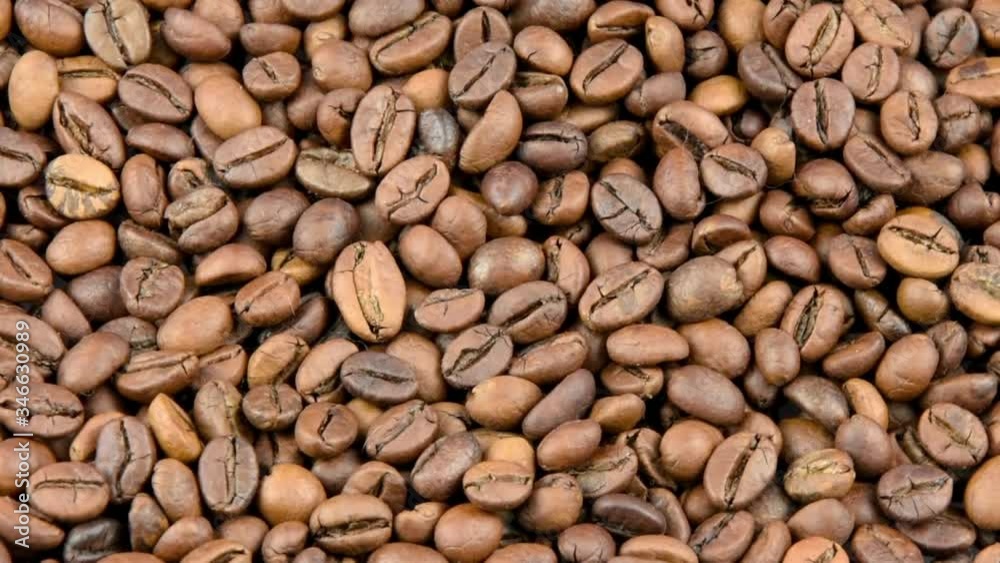 Close-up coffee beans are roasted and rotated Close-up coffee beans are roasted and rotated