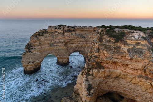 Amazing seascape at sunset at Marinha Beach in the Algarve, Portugal. Landscape with strong colors of one of the main holiday destinations in europe. Summer tourist attraction.