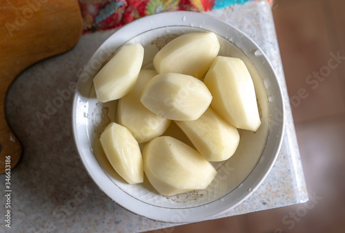 Raw washed peeled potatoes in a plate