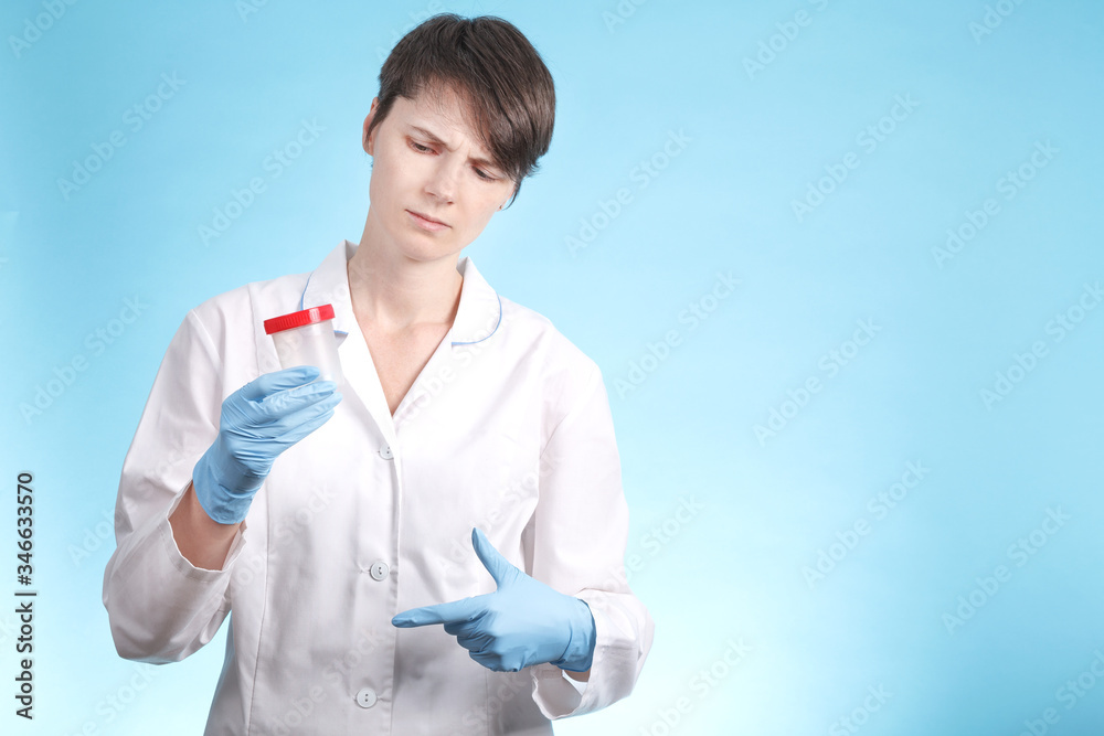 Young woman doctor holding in his hand the Bank for acceptance tests. free space on the blue background Young woman doctor holding in his hand the Bank for acceptance tests. free space on the blue background
