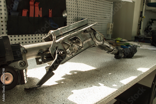 A fragment of the car steering column lies on the table, the photo at an angle.