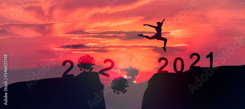 Young woman Jumping across the gap of the mountain from 2022 to 2023 New Year.