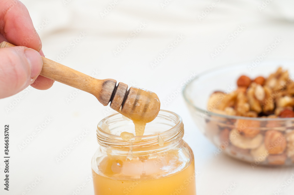 honey and nuts in blur . Healthy food concept. Vegetarian food. Raw food concept honey and nuts in blur . Healthy food concept. Vegetarian food. Raw food concept