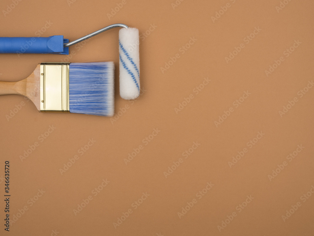 Tool for paint finishing work on beige background. The brush and roller. Tool for paint finishing work on beige background. The brush and roller.