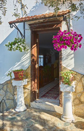 Bougainvillea flowers around the house with a balcony and tsvetami. photo