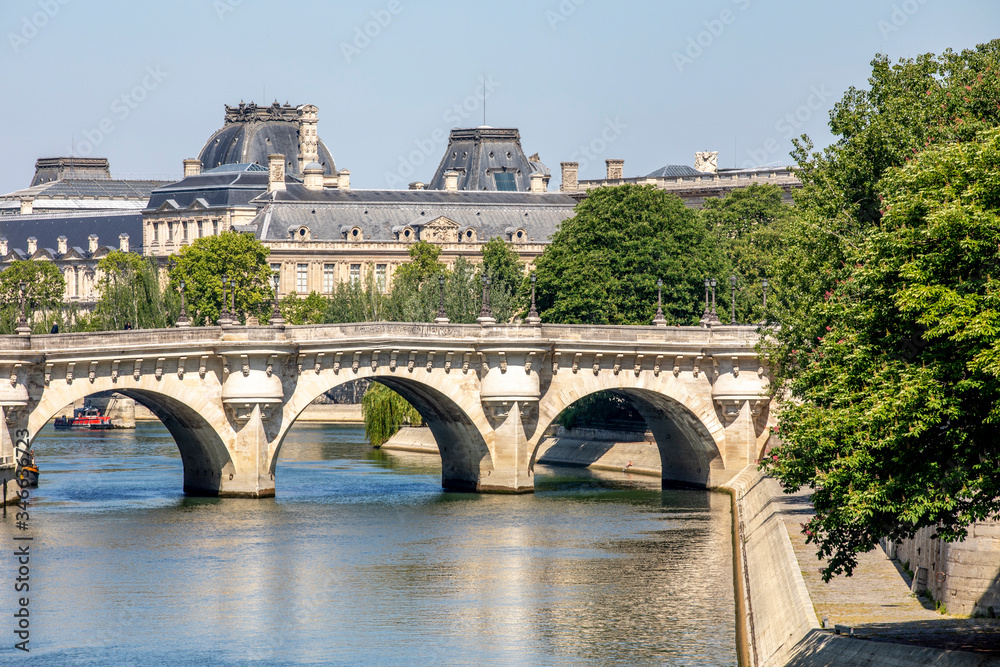 Paris, France - May 6, 2020: View of the Pont Neuf, bridge over the Seine in Paris and buildings along the river