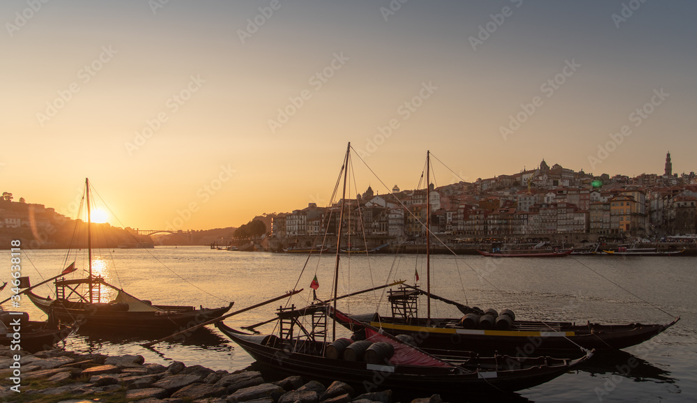 Porto cityscape in sunset with river on the front and wine carrier ship in  foreground and city of Porto in background, Portugal