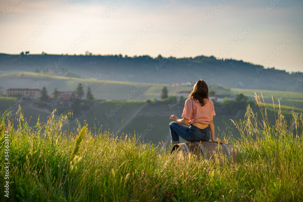 Vineyard Prosecco on the green hills near Valdobbiadene, girl looking vineyards landscape, wine area, Veneto, Italy
