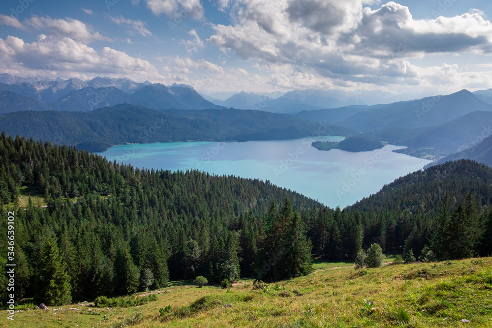 Turquoise coloured lake Walchensee from high angle view, with forest, mountains and clouds, Bavaria Germany.