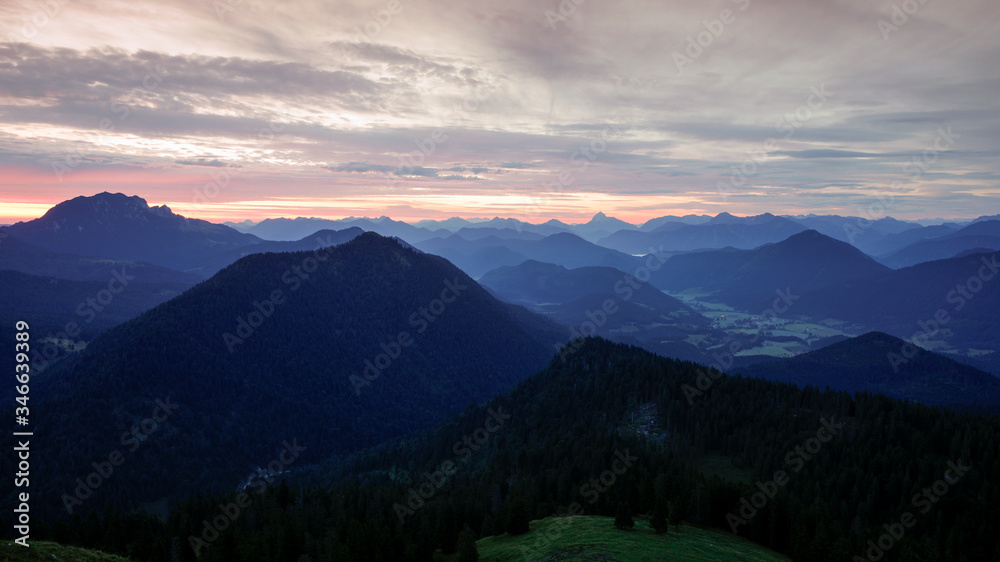 Mountain silhouettes layers of the Bavarian Alps during sunrise from Jochberg Walchensee, Bavaria Germany.