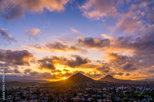 Sunset over Mountains, Puffy Clouds, Sunburst, City