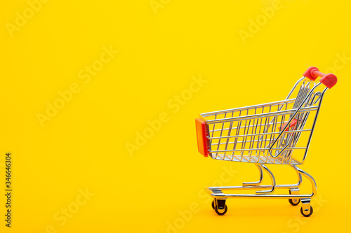 Food cart on an orange background, empty place for an inscription