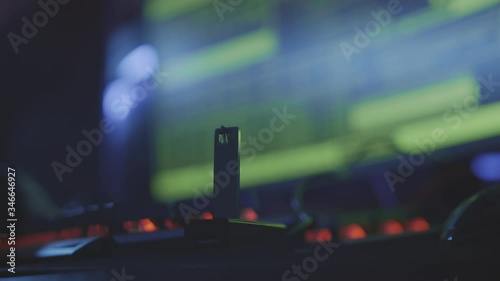 Close up of unrecognizable person hand connecting USB flash drive to the computer in dark computer club