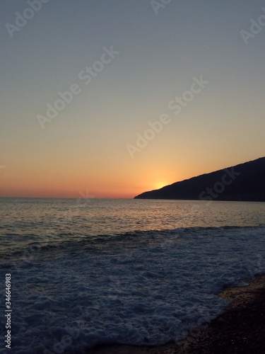 Sunset on the black sea. Black  red  orange colours. Beach  sky  sea. Photo taken in summer on vacation.