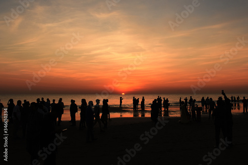 People on the beach at sunset