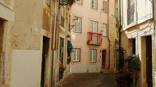 Walking along the picturesque streets of Alfama, the oldest district of Lisbon, Portugal, on the slope of the Sao Jorge Castle photo